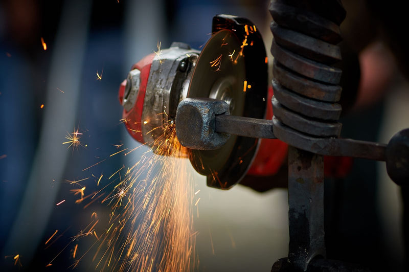 Sparks flying as a blade is ground and sharpened